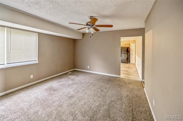 6363 Coventry Dr, Florissant, MO 63033 - spare room featuring ceiling fan, carpet, baseboards, and a textured ceiling