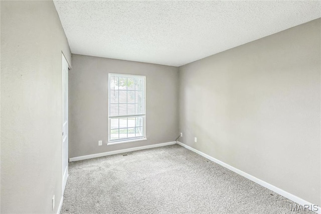 6363 Coventry Dr, Florissant, MO 63033 - carpeted empty room with baseboards and a textured ceiling