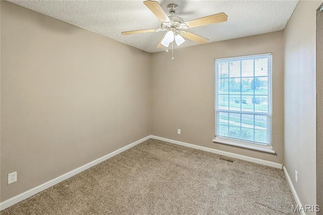 6363 Coventry Dr, Florissant, MO 63033 - carpeted empty room featuring a textured ceiling, baseboards, and a ceiling fan