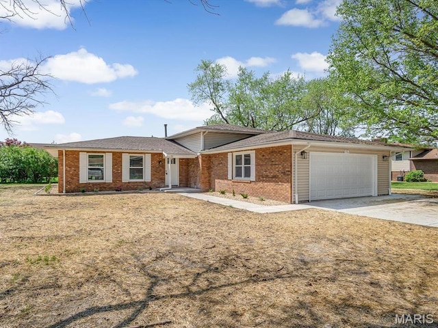 496 E 2nd St, Trenton, IL 62293 - view of front facade featuring an attached garage, brick siding, and driveway