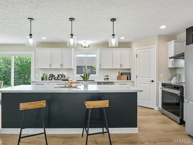 496 E 2nd St, Trenton, IL 62293 - kitchen featuring range with electric stovetop, a textured ceiling, plenty of natural light, white cabinetry, and recessed lighting