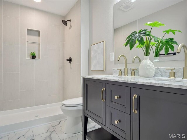 496 E 2nd St, Trenton, IL 62293 - full bathroom featuring marble look tiles, vanity, a tile shower, and toilet