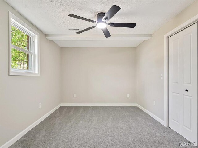 496 E 2nd St, Trenton, IL 62293 - unfurnished bedroom with carpet, baseboards, a textured ceiling, ceiling fan, and beamed ceiling