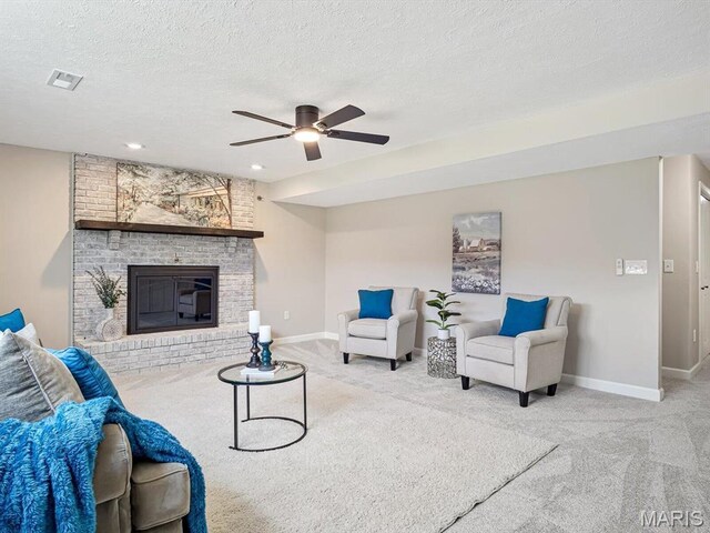 496 E 2nd St, Trenton, IL 62293 - living room with carpet, a ceiling fan, baseboards, a brick fireplace, and a textured ceiling