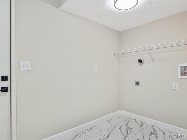 496 E 2nd St, Trenton, IL 62293 - laundry area featuring hookup for an electric dryer, light marble finish flooring, baseboards, washer hookup, and a textured ceiling