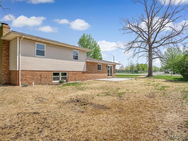496 E 2nd St, Trenton, IL 62293 - view of property exterior featuring brick siding, a chimney, and a patio area