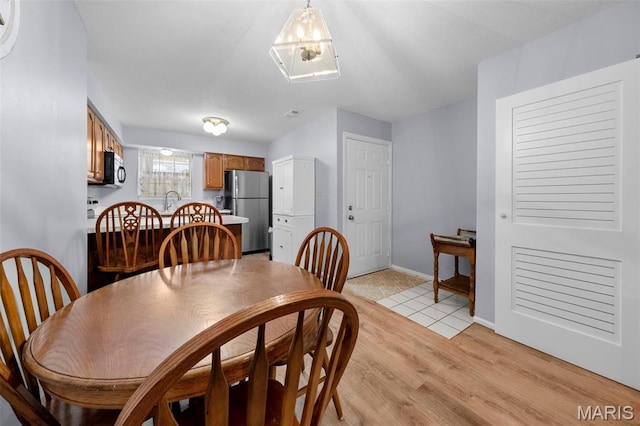 12944 Bryce Canyon Dr, Maryland Heights, MO 63043 - dining room with light wood-style flooring and baseboards