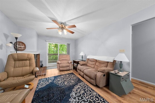 12944 Bryce Canyon Dr, Maryland Heights, MO 63043 - living area with light wood-style flooring, a ceiling fan, and baseboards
