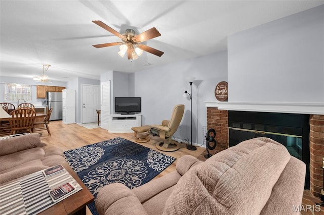 12944 Bryce Canyon Dr, Maryland Heights, MO 63043 - living area featuring a fireplace, light wood finished floors, and a ceiling fan
