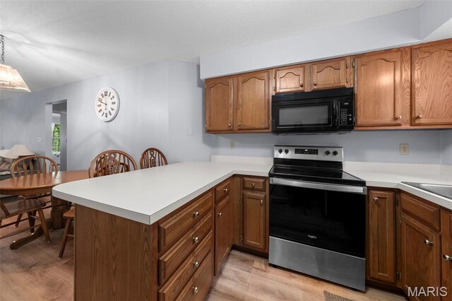 12944 Bryce Canyon Dr, Maryland Heights, MO 63043 - kitchen featuring stainless steel range with electric stovetop, black microwave, light wood-style flooring, and a peninsula