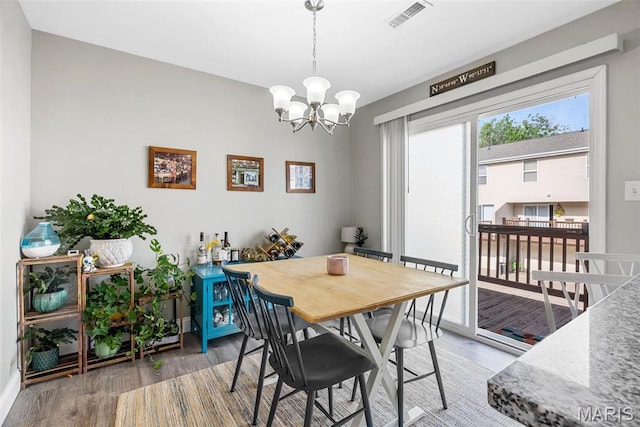 38 Trailside Ct Unit 3, Saint Charles, MO 63303 - dining space featuring wood finished floors, a chandelier, and baseboards
