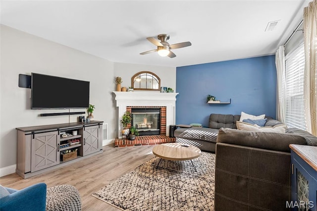 38 Trailside Ct Unit 3, Saint Charles, MO 63303 - living area featuring ceiling fan, light wood-type flooring, baseboards, and a brick fireplace