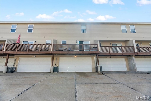 38 Trailside Ct Unit 3, Saint Charles, MO 63303 - rear view of property featuring an attached garage, cooling unit, and driveway