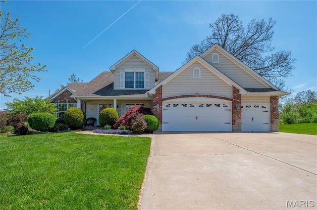 1004 Kodiak Ct, Wentzville, MO 63385 - view of front of house featuring driveway, a garage, a front lawn, brick siding, and roof with shingles