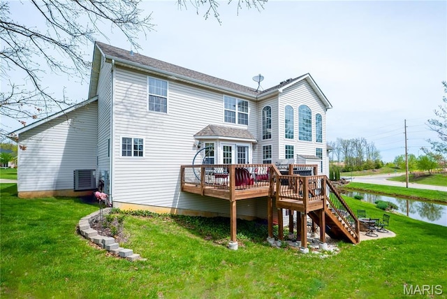 1004 Kodiak Ct, Wentzville, MO 63385 - back of house featuring a deck with water view, a lawn, and stairs