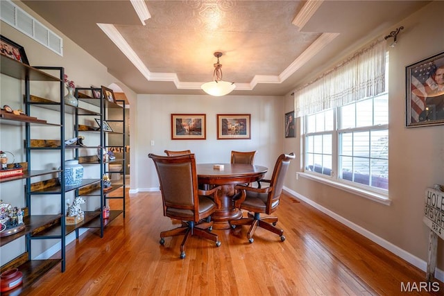 1004 Kodiak Ct, Wentzville, MO 63385 - dining area with a raised ceiling, wood finished floors, and ornamental molding