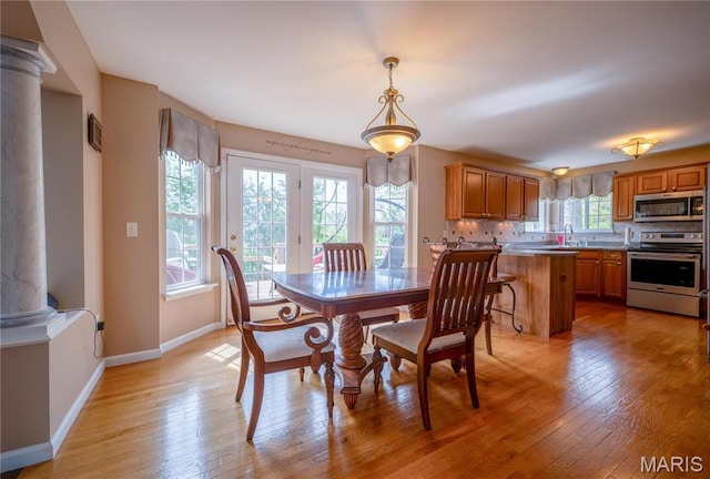 1004 Kodiak Ct, Wentzville, MO 63385 - dining area featuring decorative columns and light wood-style flooring