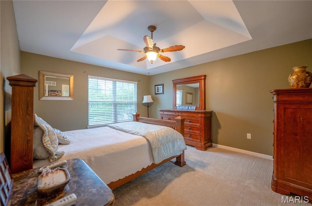 1004 Kodiak Ct, Wentzville, MO 63385 - bedroom featuring a tray ceiling, light carpet, and a ceiling fan