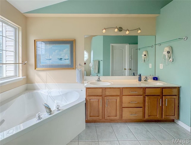 1004 Kodiak Ct, Wentzville, MO 63385 - full bathroom featuring double vanity, a bath, tile patterned flooring, and lofted ceiling