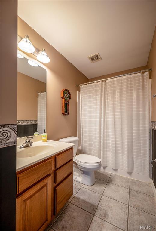 1004 Kodiak Ct, Wentzville, MO 63385 - bathroom featuring vanity, tile patterned flooring, and a shower with shower curtain