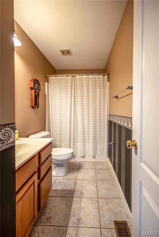 1004 Kodiak Ct, Wentzville, MO 63385 - full bathroom with vanity, tile patterned floors, and a shower with shower curtain