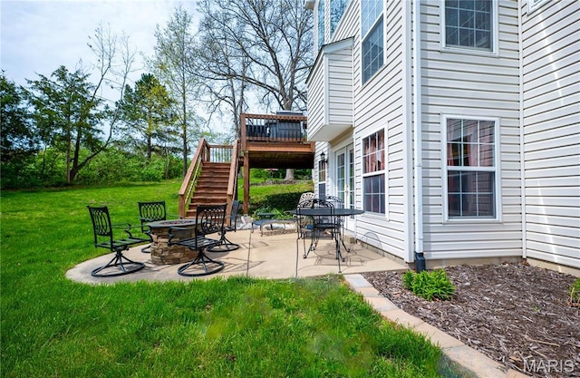 1004 Kodiak Ct, Wentzville, MO 63385 - view of grassy yard with stairway, a fire pit, a deck, and a patio area