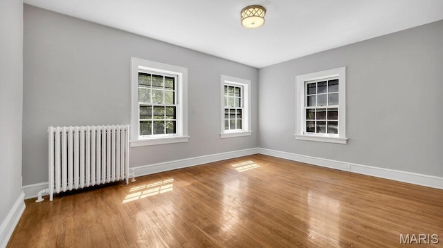 9 Aberdeen Pl, Saint Louis, MO 63105 - unfurnished room with radiator, wood finished floors, and baseboards