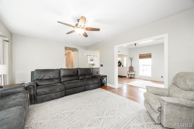 1237 Conrad Ln, Ofallon, IL 62269 - living room featuring ceiling fan, wood finished floors, baseboards, and arched walkways