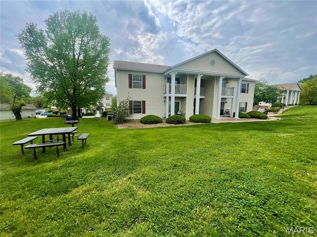 3114 Edwards Pl Unit 304, Maryland Heights, MO 63043 - rear view of property with a balcony and a lawn
