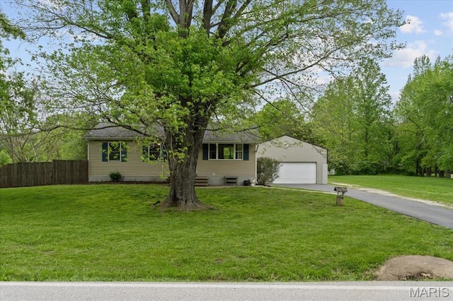 view of front facade featuring an outdoor structure, asphalt driveway, and a detached garage