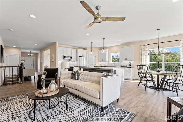 134 Columbia Meadows Ln, Ofallon, MO 63366 - living room with a chandelier, light wood-style flooring, ceiling fan, and recessed lighting