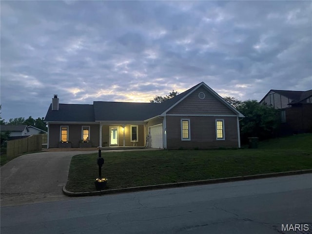 303 Greenbriar, Rolla, MO 65401 - view of front facade featuring driveway, an attached garage, and a chimney