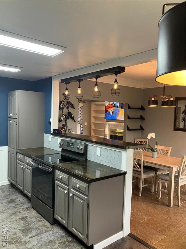 303 Greenbriar, Rolla, MO 65401 - kitchen featuring black electric range oven, dark countertops, a peninsula, gray cabinets, and crown molding