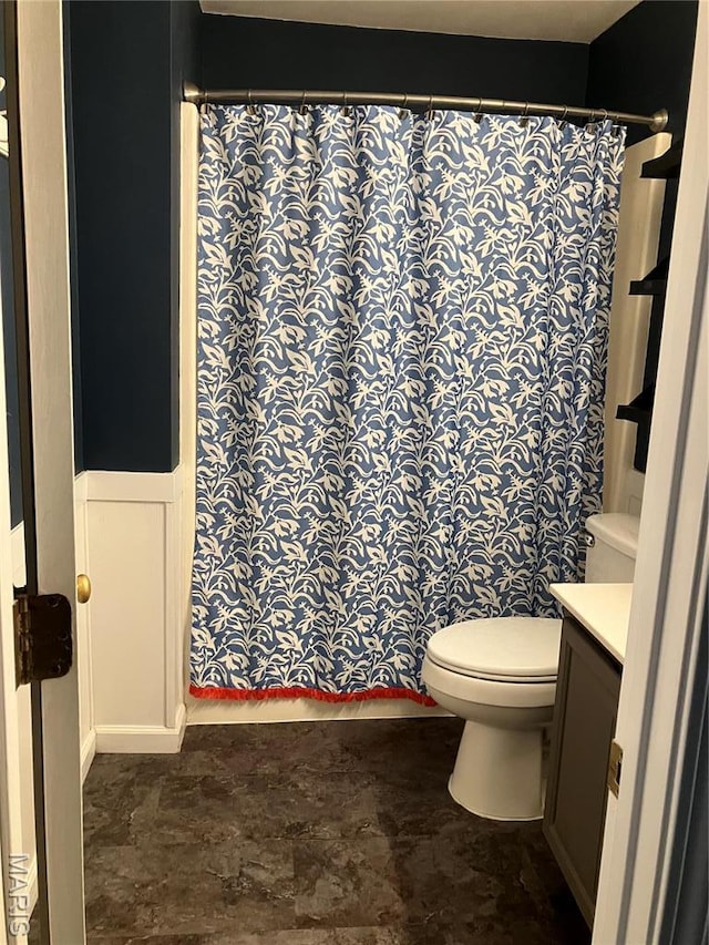 303 Greenbriar, Rolla, MO 65401 - bathroom with vanity, toilet, a shower with shower curtain, and wainscoting