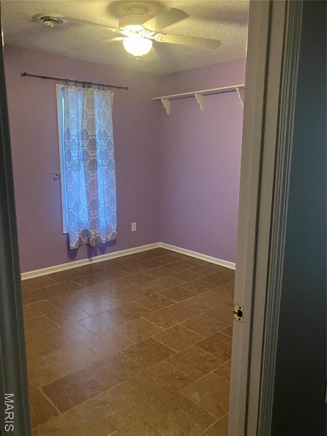 303 Greenbriar, Rolla, MO 65401 - empty room featuring a textured ceiling, ceiling fan, and baseboards
