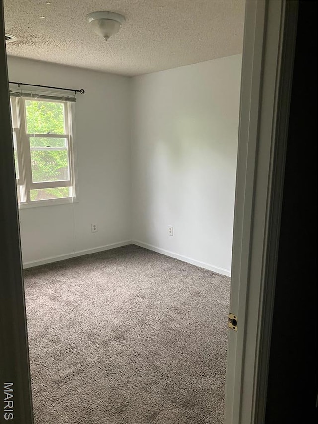 303 Greenbriar, Rolla, MO 65401 - carpeted empty room featuring a textured ceiling and baseboards