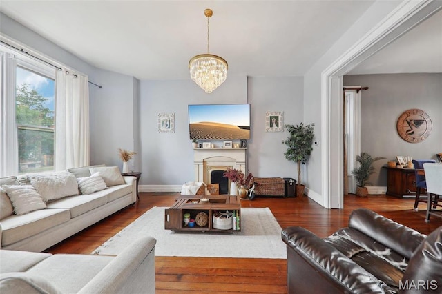 2116 Victor St, Saint Louis, MO 63104 - living room featuring a chandelier, wood finished floors, a fireplace, and baseboards