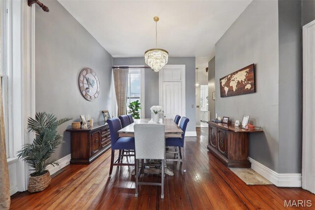 2116 Victor St, Saint Louis, MO 63104 - dining area featuring a chandelier, dark wood-style floors, and baseboards