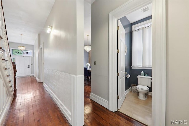2116 Victor St, Saint Louis, MO 63104 - corridor with dark wood-style floors, a chandelier, stairway, and baseboards