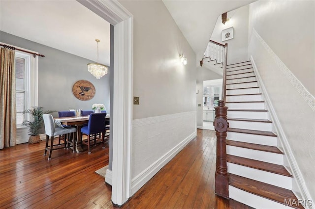 2116 Victor St, Saint Louis, MO 63104 - stairway featuring hardwood / wood-style floors, a chandelier, and high vaulted ceiling