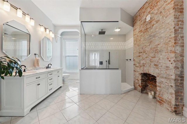 2116 Victor St, Saint Louis, MO 63104 - full bath featuring tile patterned flooring, a fireplace, a walk in shower, and double vanity