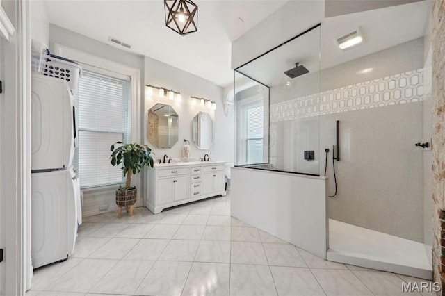 2116 Victor St, Saint Louis, MO 63104 - bathroom with stacked washer / drying machine, tile patterned floors, walk in shower, and vanity
