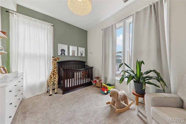 2116 Victor St, Saint Louis, MO 63104 - bedroom with carpet floors and a crib