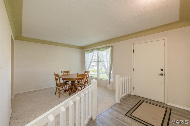 6344 Gibison Rd, Troy, MO 63379 - dining area with wood finished floors, a textured ceiling, and baseboards