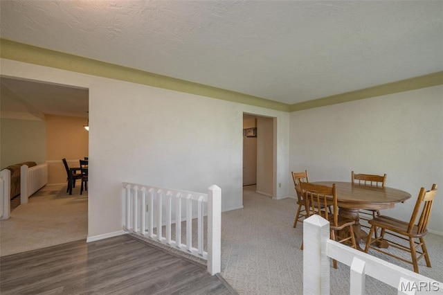 6344 Gibison Rd, Troy, MO 63379 - dining area with carpet floors, wood finished floors, and baseboards