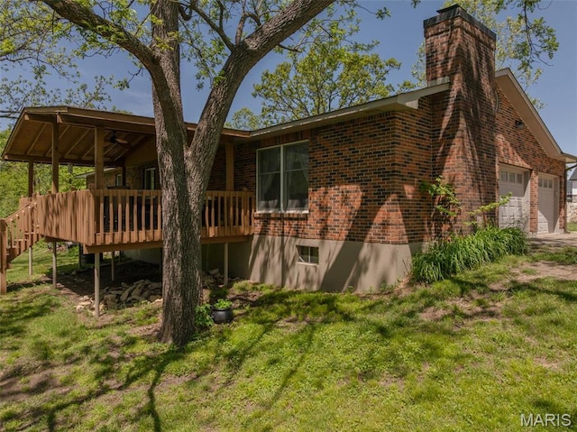 6344 Gibison Rd, Troy, MO 63379 - rear view of house featuring brick siding, a chimney, a wooden deck, and a lawn
