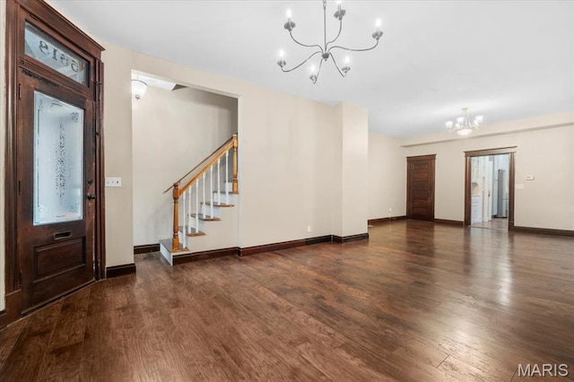 5518 Alaska Ave, Saint Louis, MO 63111 - foyer entrance with a chandelier, wood finished floors, stairway, and baseboards