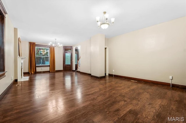 5518 Alaska Ave, Saint Louis, MO 63111 - unfurnished living room featuring a chandelier, wood finished floors, and baseboards