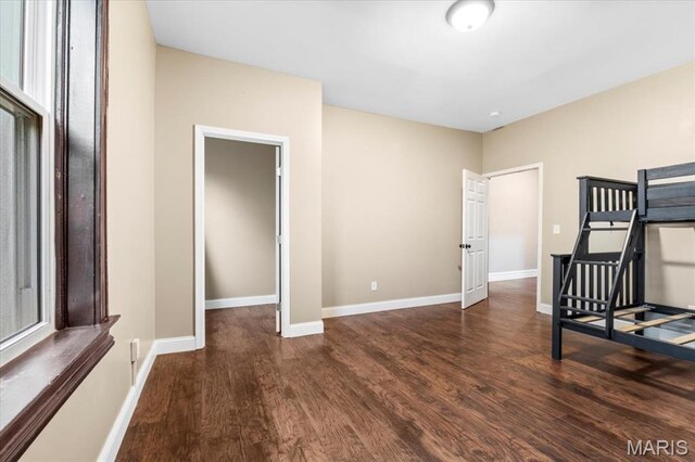 5518 Alaska Ave, Saint Louis, MO 63111 - unfurnished bedroom with wood finished floors and baseboards