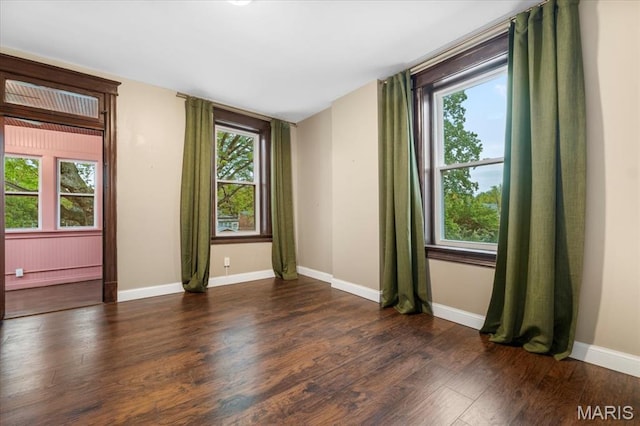 5518 Alaska Ave, Saint Louis, MO 63111 - empty room with healthy amount of natural light, wood finished floors, and baseboards